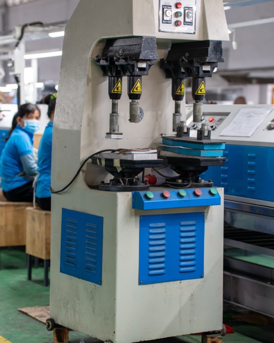 A single-purpose press standing on the factory floor between production lines.